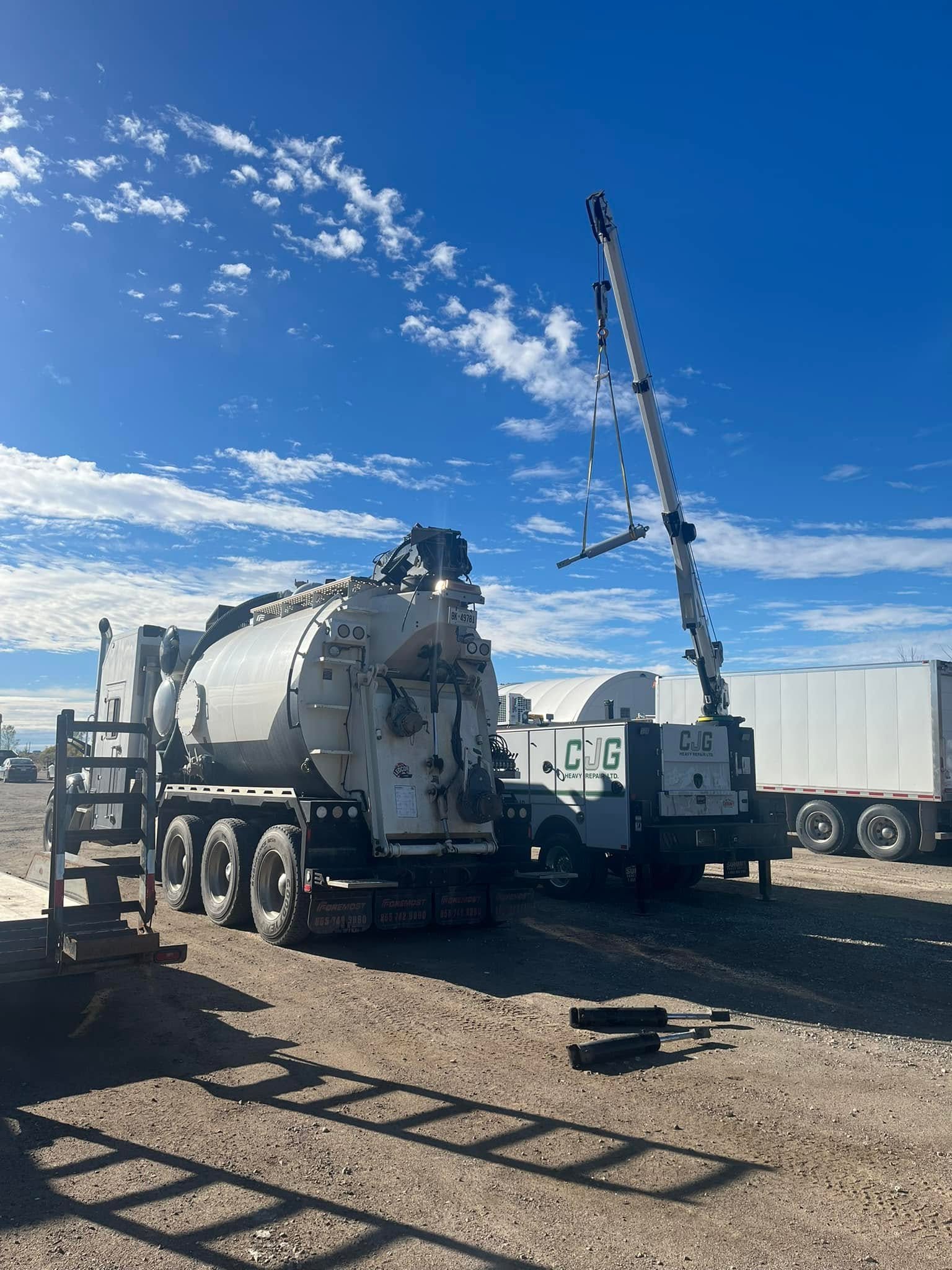 Technician performing mobile AC repair on heavy eq